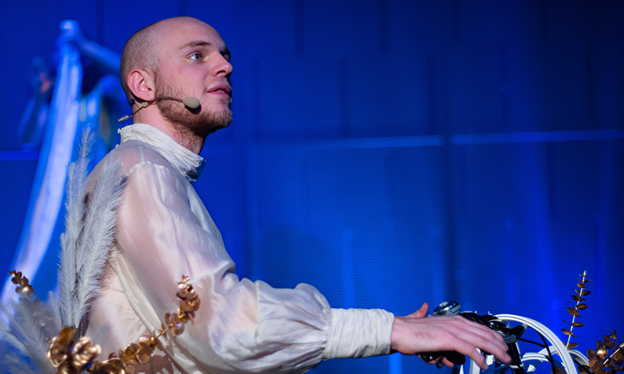 Eine Person in weißer Bluse mit Mikro-Headset